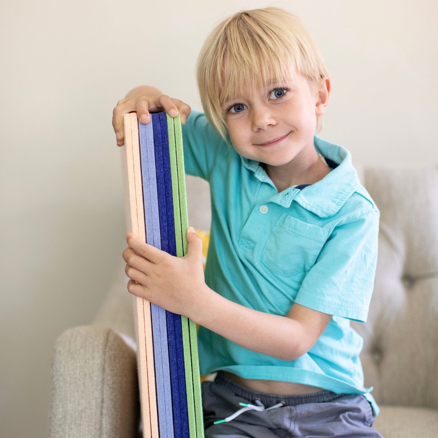child holding colorful interlocking blocks classic set with felt board