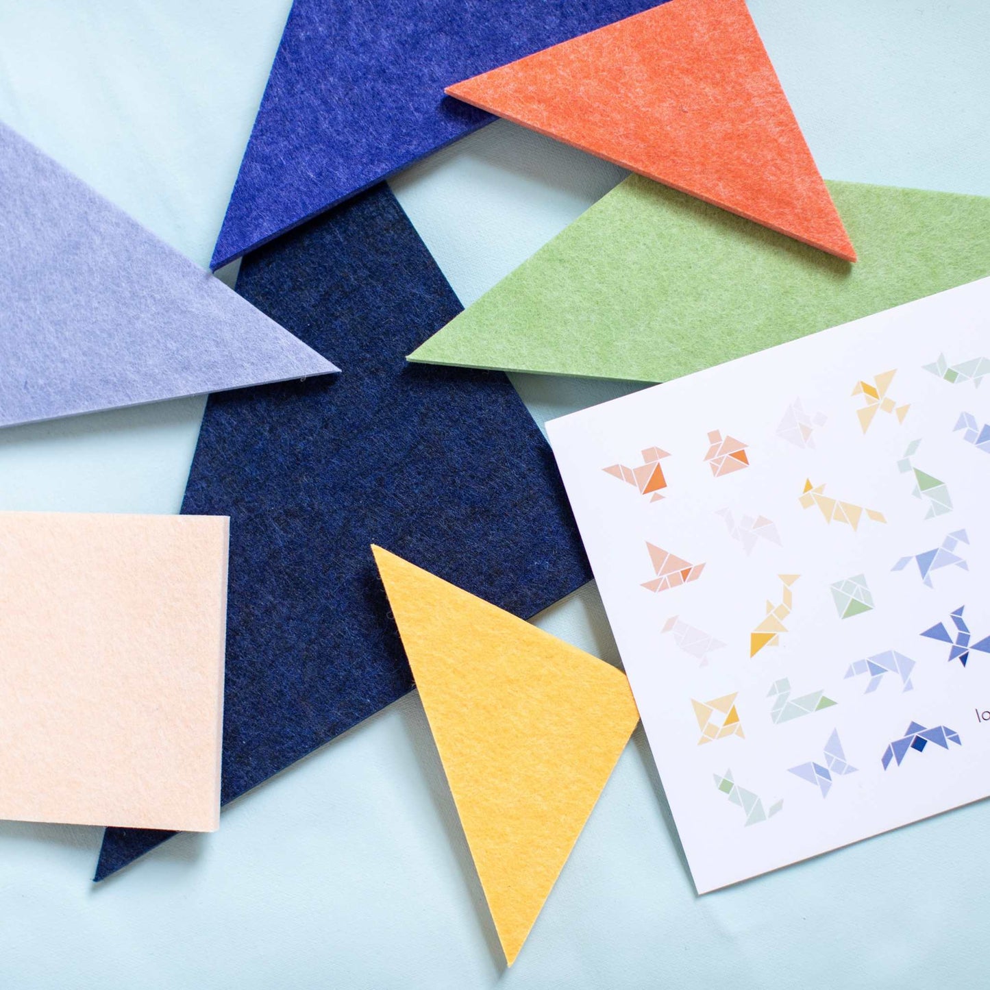 Printable tangram patterns with colorful tangram pieces and pattern sheet for cutting and coloring activities