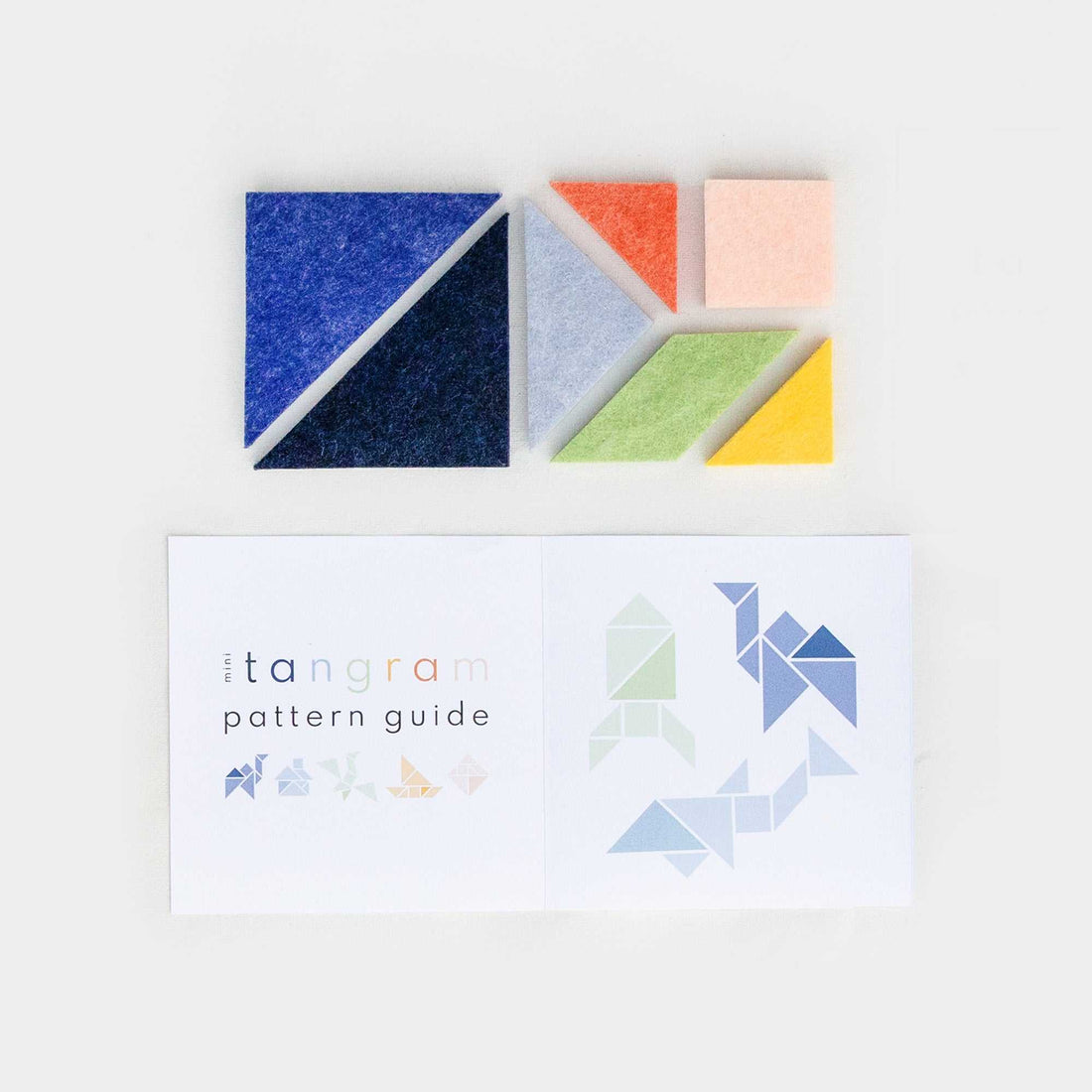 Lowercase Toys Mini Tangram set featuring seven recycled felt geometric pieces tucked into a compact travel pouch, designed for quiet, on-the-go STEM learning.