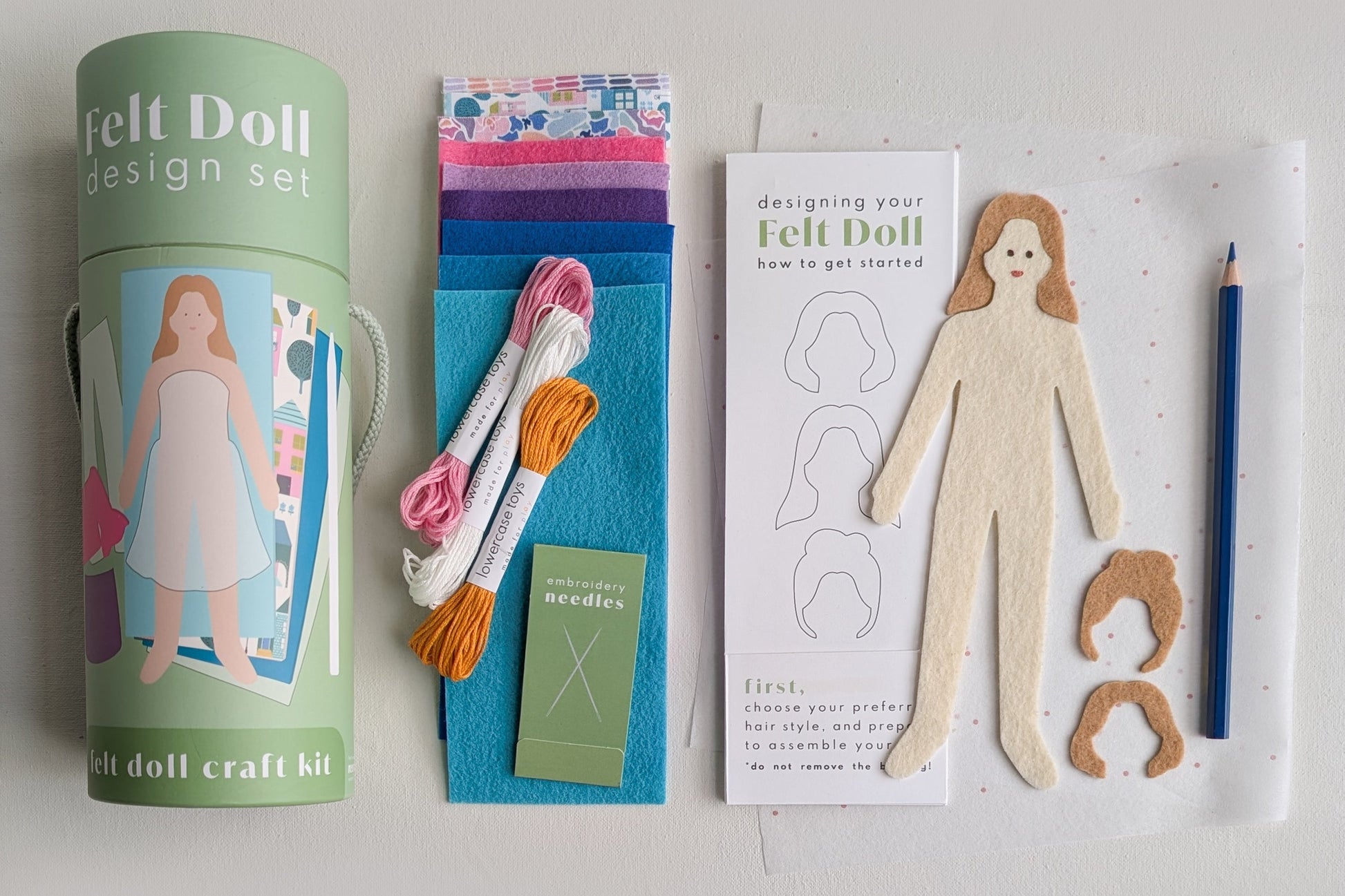 Felt doll design set with materials and instructions on a light gray background